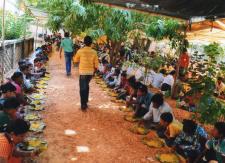 Devotee taking Basanti Devi Puja Prasad 